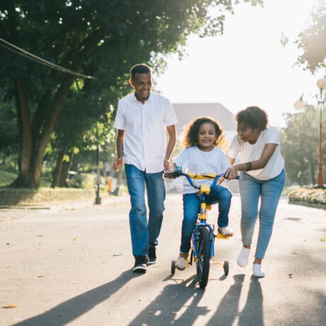 husband wife child on bicycle